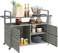 Outsunny PE Rattan Outdoor Storage Cabinet, Wicker Outdoor Bar Table Kitchen Island with Wheels & 2-Tier Shelf, Patio Serving Cart with Glass Top, Handles, Towel Racks for Poolside, Mixed Gray